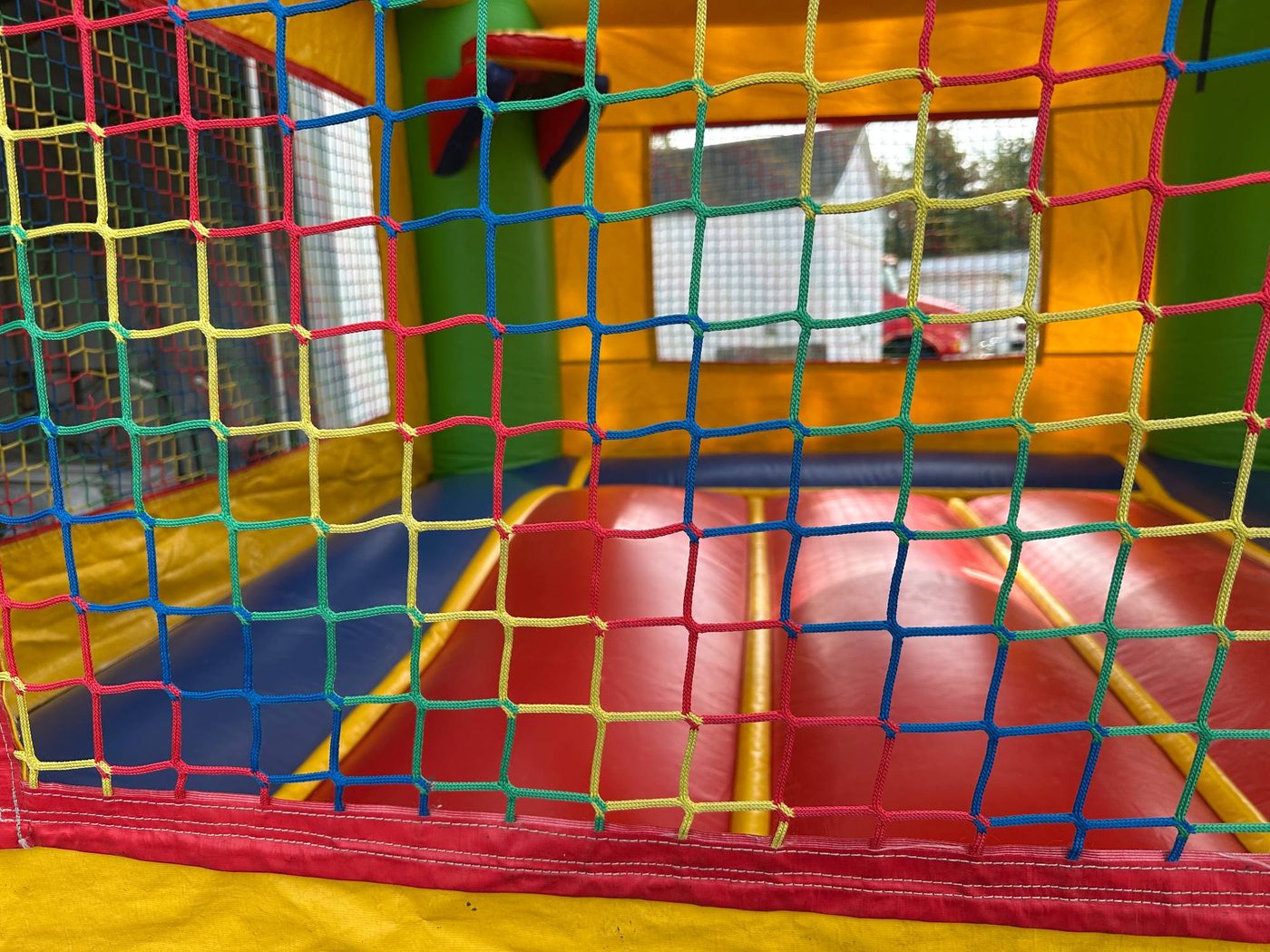 Before photo of blown internal baffle repair on a bounce house, completed by Stitches For Bounces