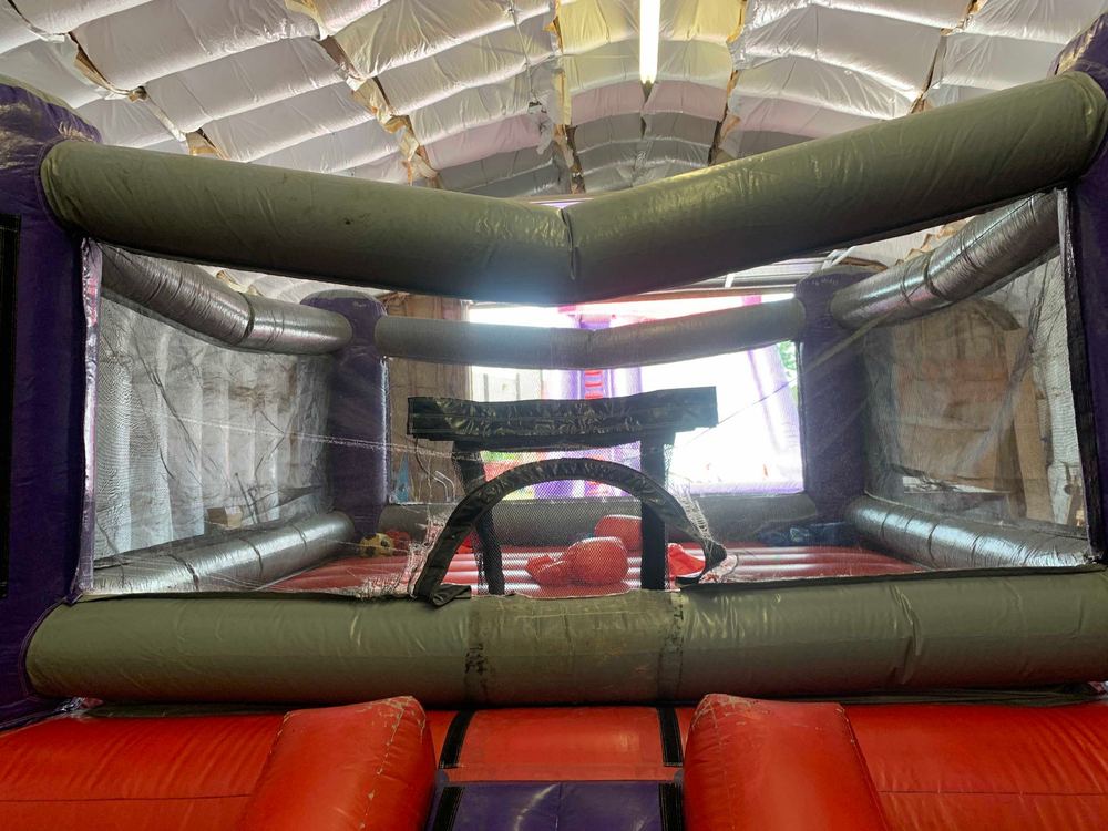 Before photo of blown internal baffle repair on a bounce house, completed by Stitches For Bounces