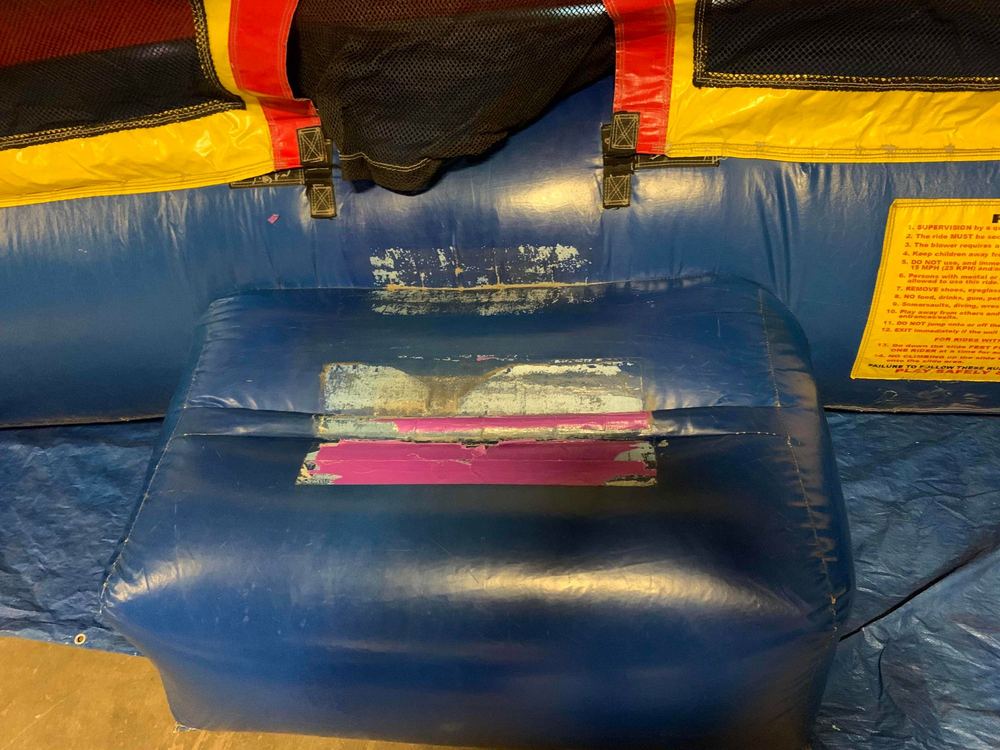 Before photo of blown internal baffle repair on a bounce house, completed by Stitches For Bounces