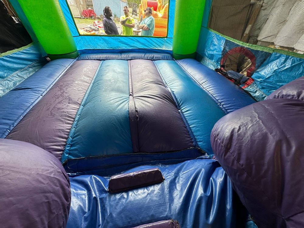 Before photo of blown internal baffle repair inside a combo bounce house unit, completed by Stitches For Bounces