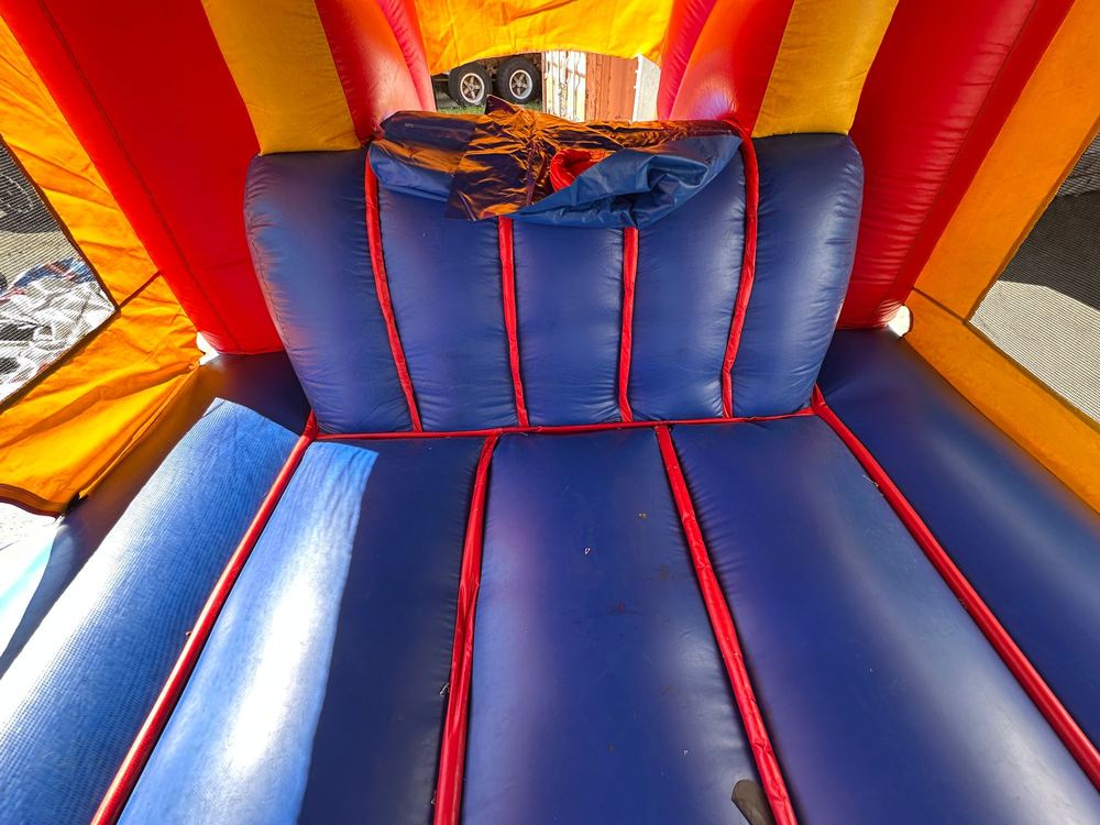After photo of frayed seam stitching repaired on a combo bounce house unit, completed by Stitches For Bounces