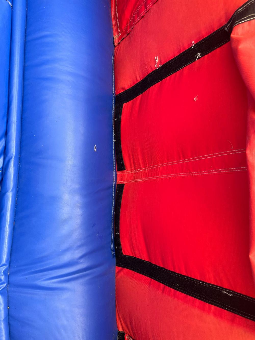 After photo of the torn panel opening resealed with the velcro closure on a combo bounce house, completed by Stitches For Bounces