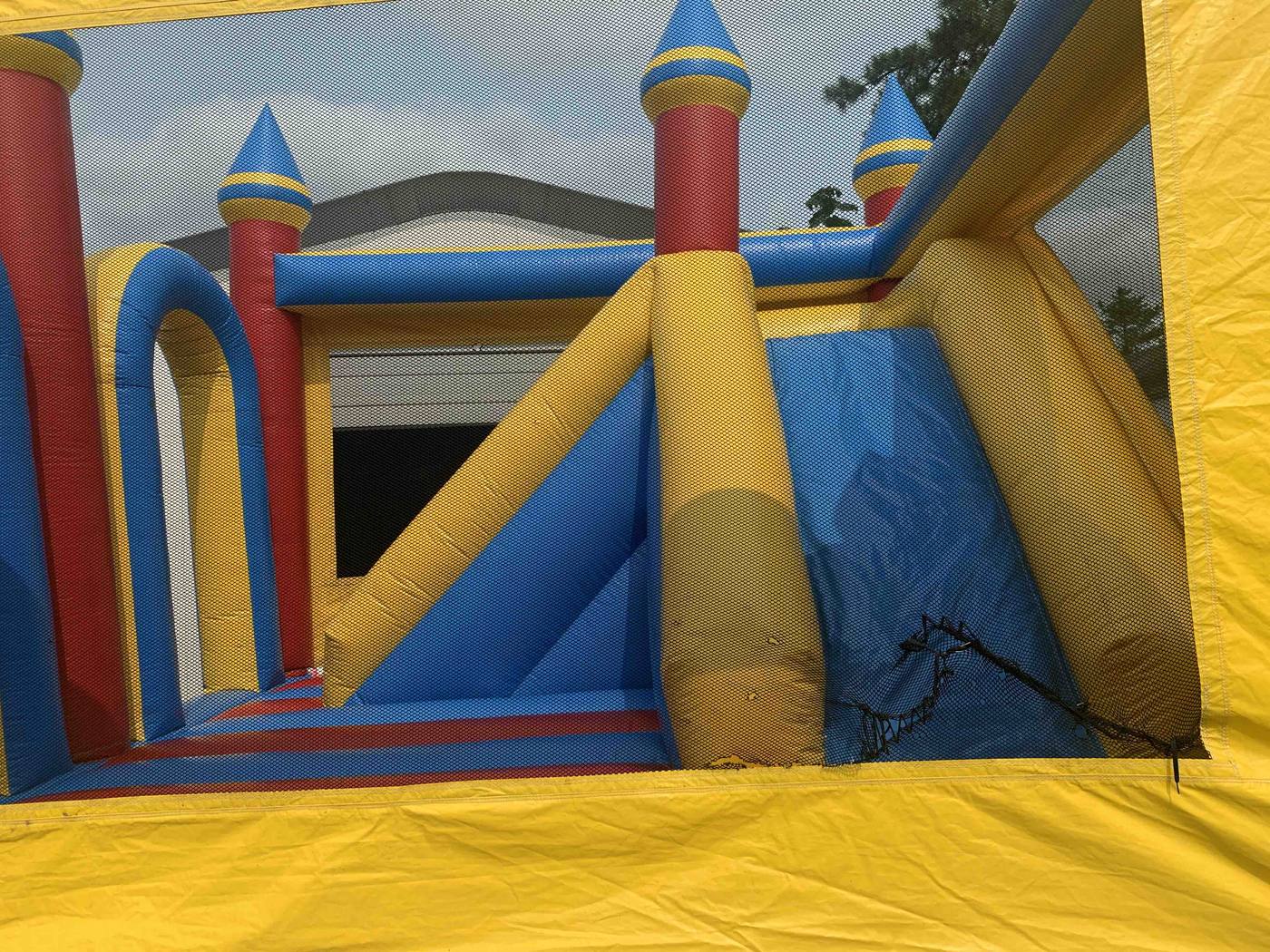 Before photo of mesh window repair on an inflatable bounce house, completed by Stitches For Bounces