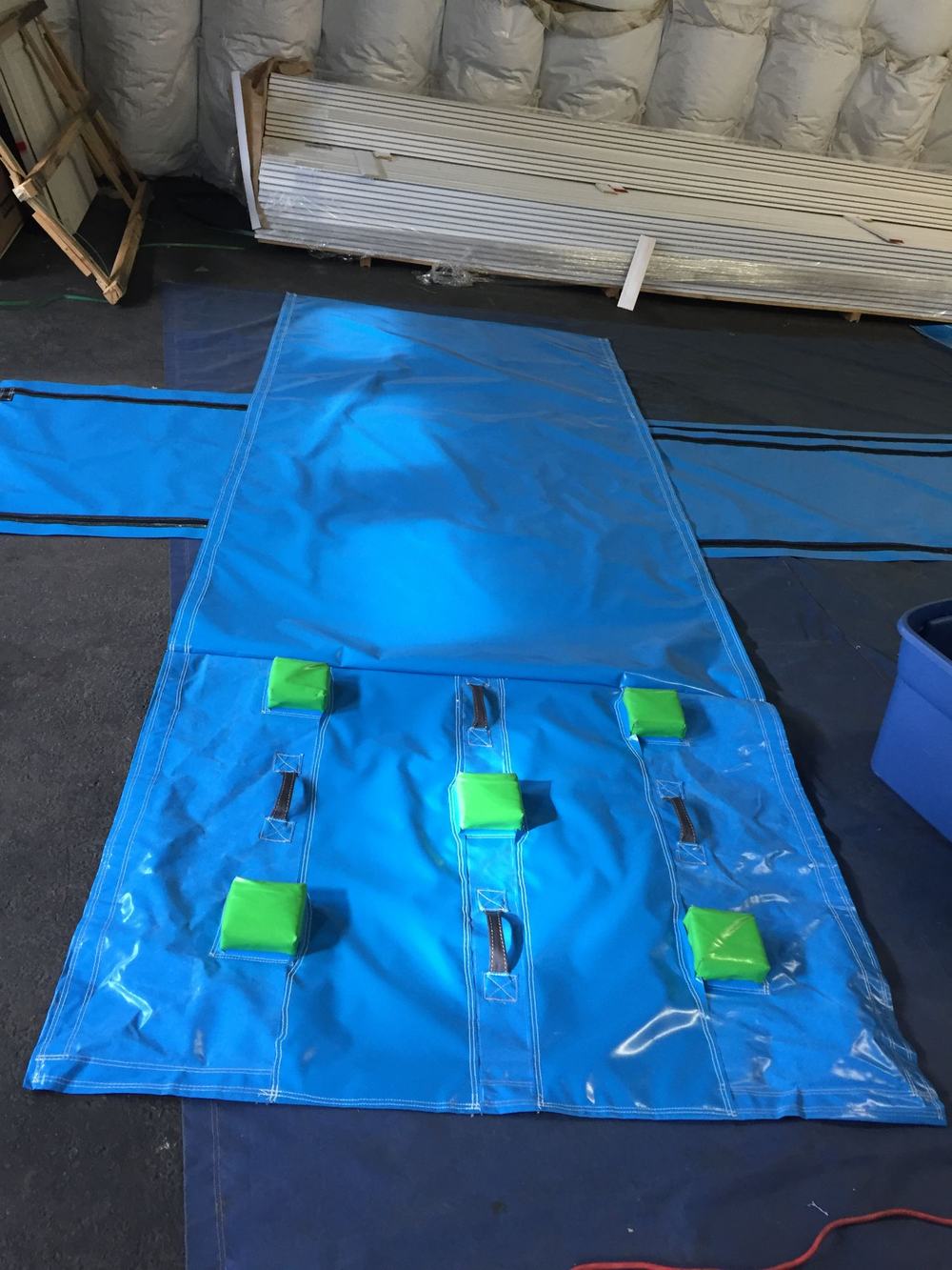 Real example of a custom water slide climbing pad cover with grip pads and handles, made by Stitches For Bounces