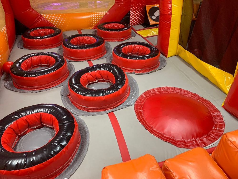 After photo of the inflatable pop-up obstacle ring repaired and reinstalled, completed by Stitches For Bounces