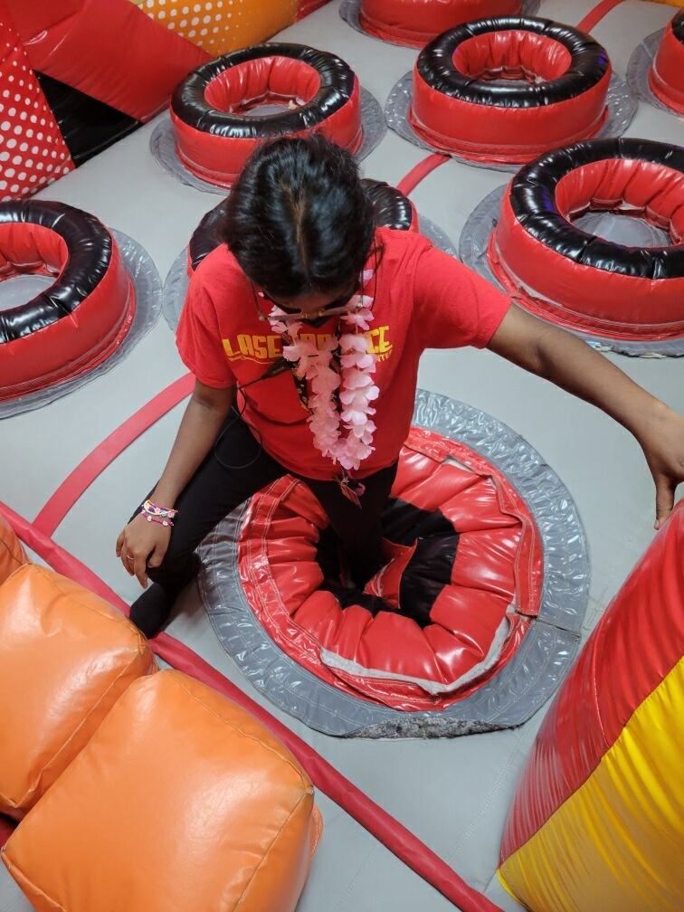 Before photo of a torn inflatable pop-up obstacle ring in an obstacle course, completed by Stitches For Bounces