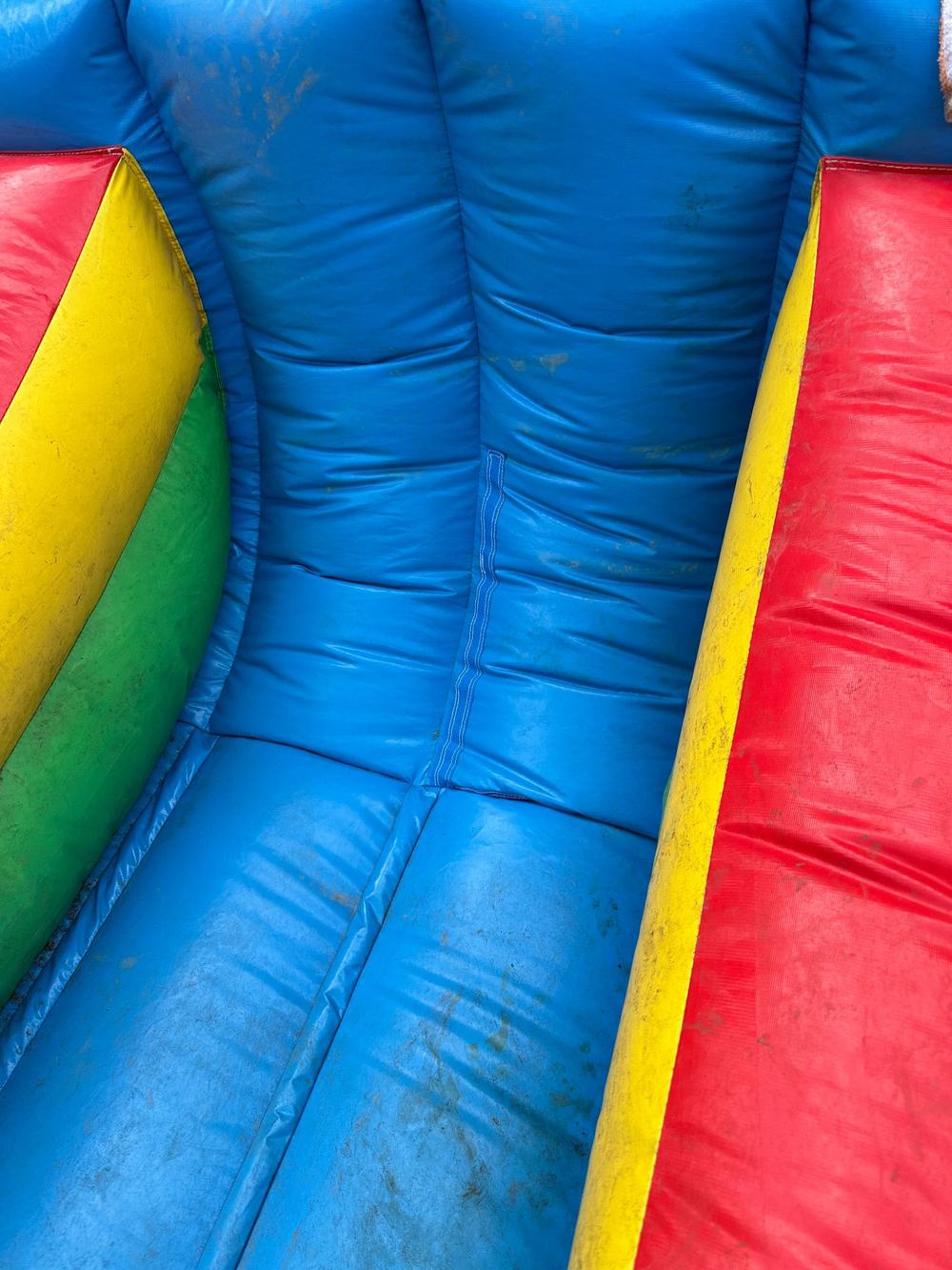After photo of the seam resewn and closed near the base of the inflatable water slide, completed by Stitches For Bounces
