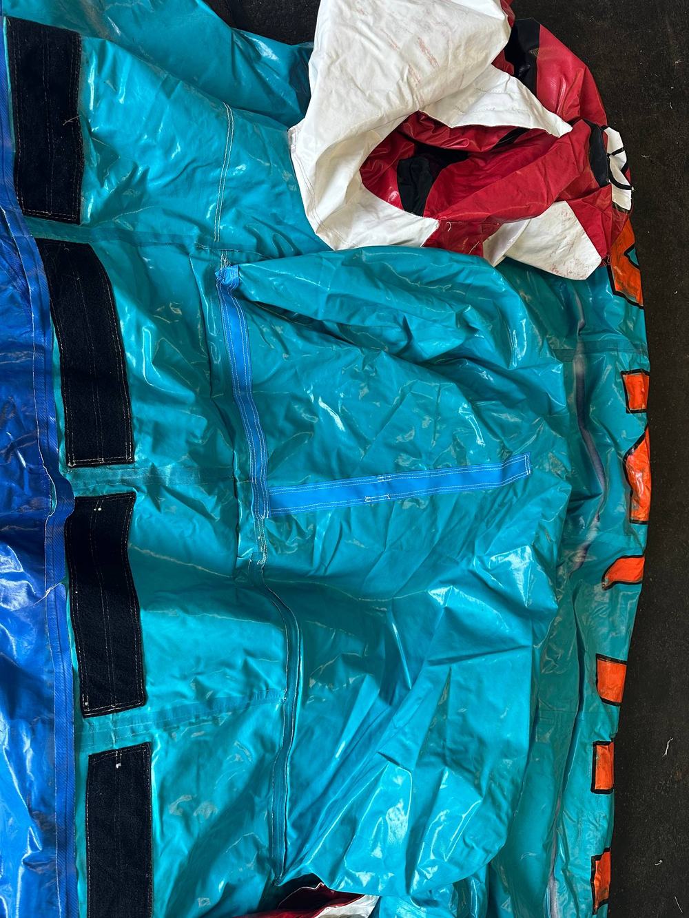 After photo of the teal water slide panel with the seam fully resewn, completed by Stitches For Bounces